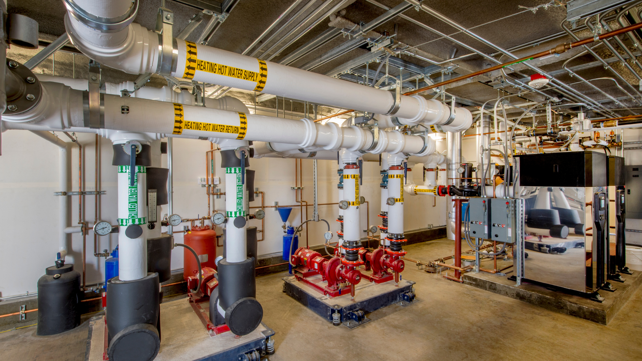 Industrial boiler system with labeled hot water supply and return lines protected by oxygen scavenger treatment.