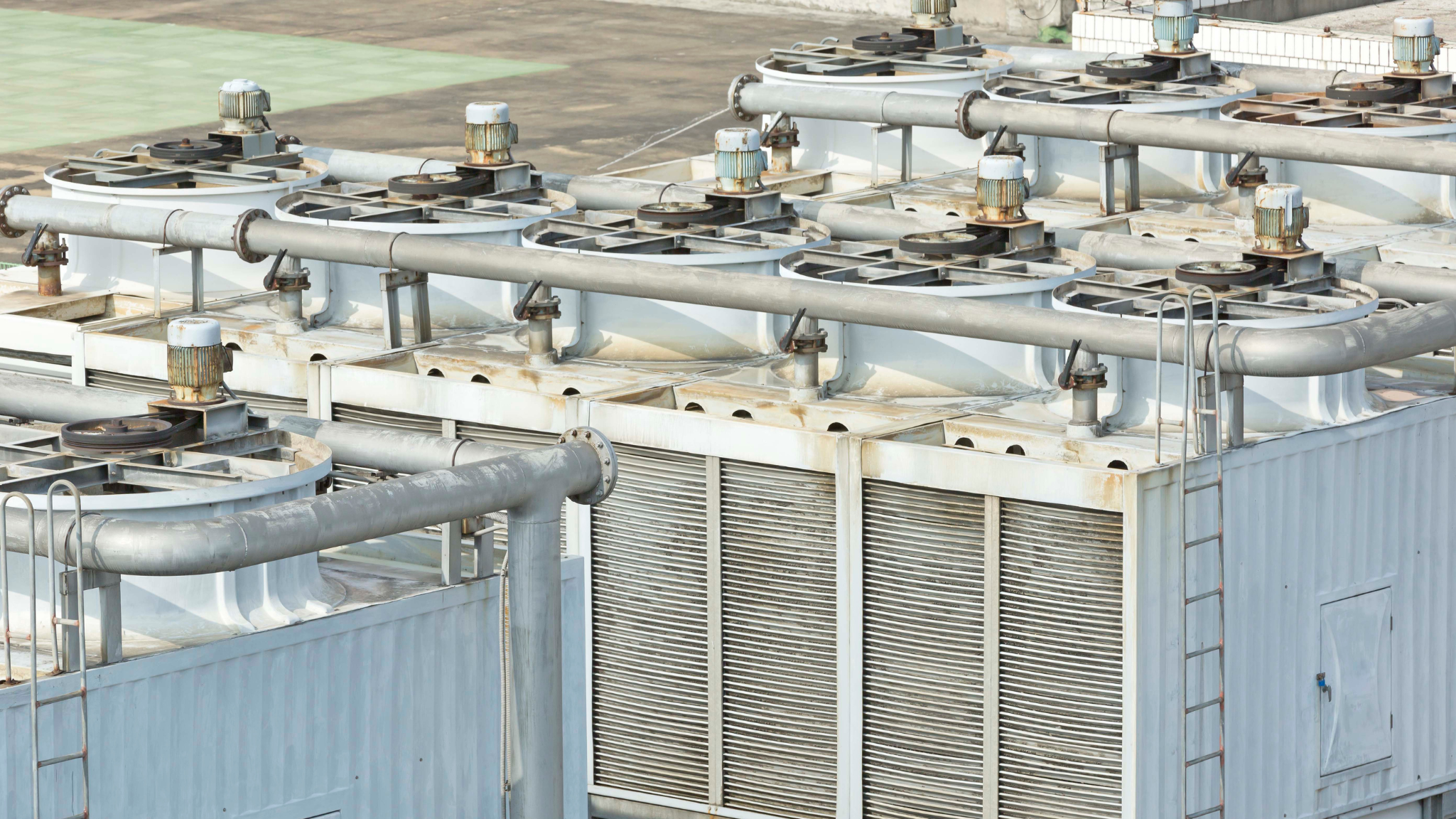 Industrial adiabatic cooling towers with fan units and coil sections for efficient heat transfer"