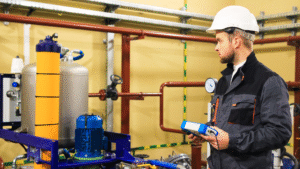 Engineer inspecting hotel water treatment system, emphasizing the importance of water treatment in hospitality operations