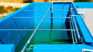 Industrial water treatment basin with piping system, where sodium permanganate is applied for oxidation