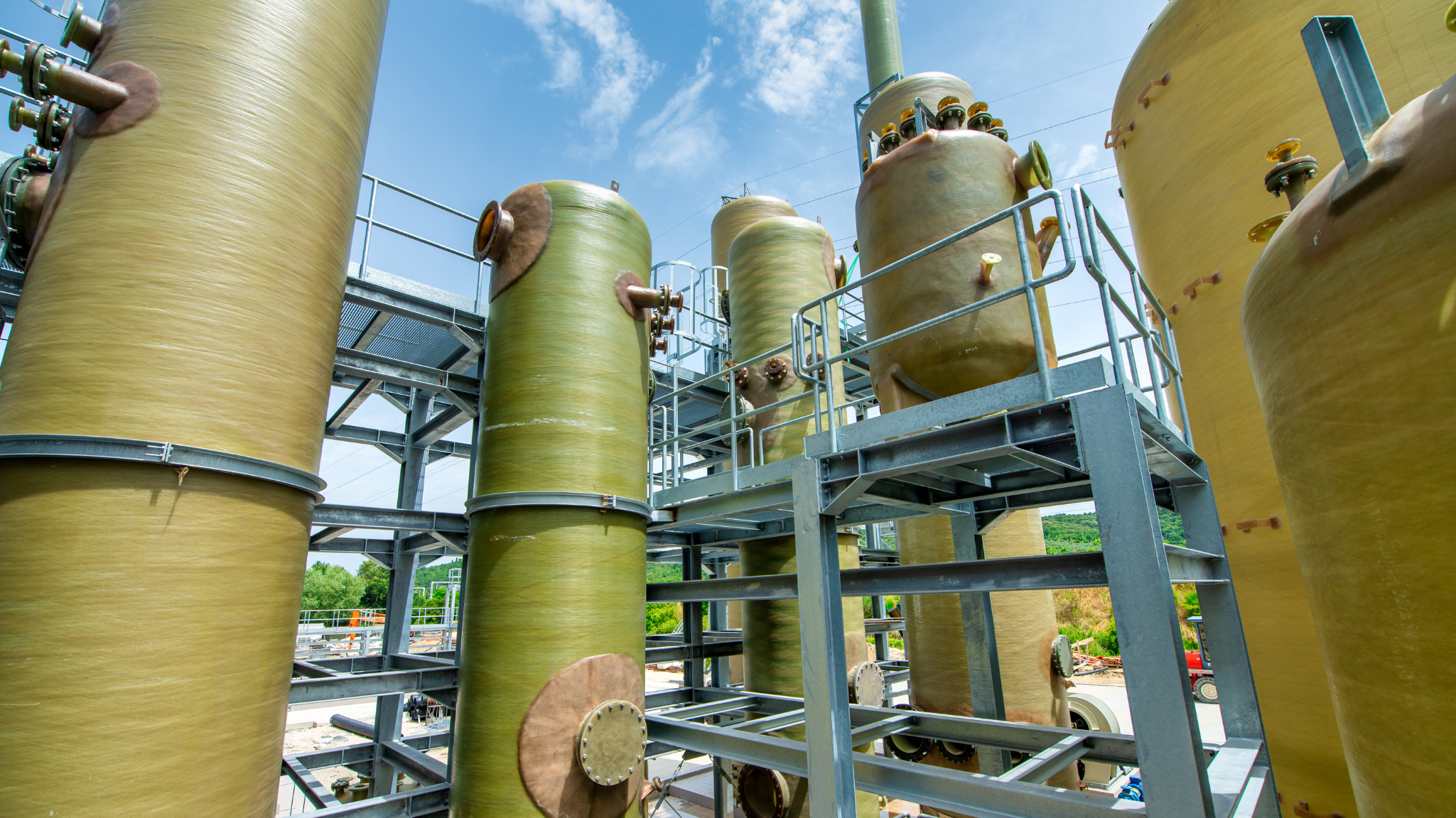 Industrial chemical blending tanks used in water treatment facility.
