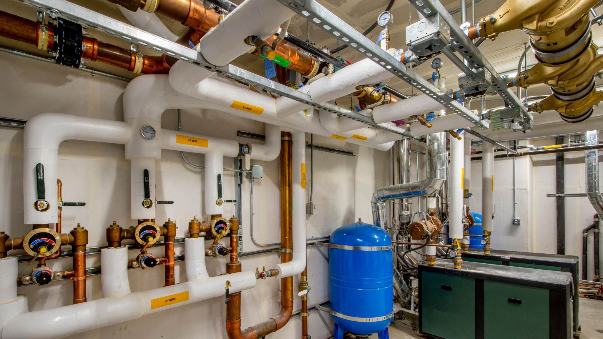 Closed loop control system in an industrial mechanical room demonstrating effective microbiological control through optimized water treatment and custom chemical blending.