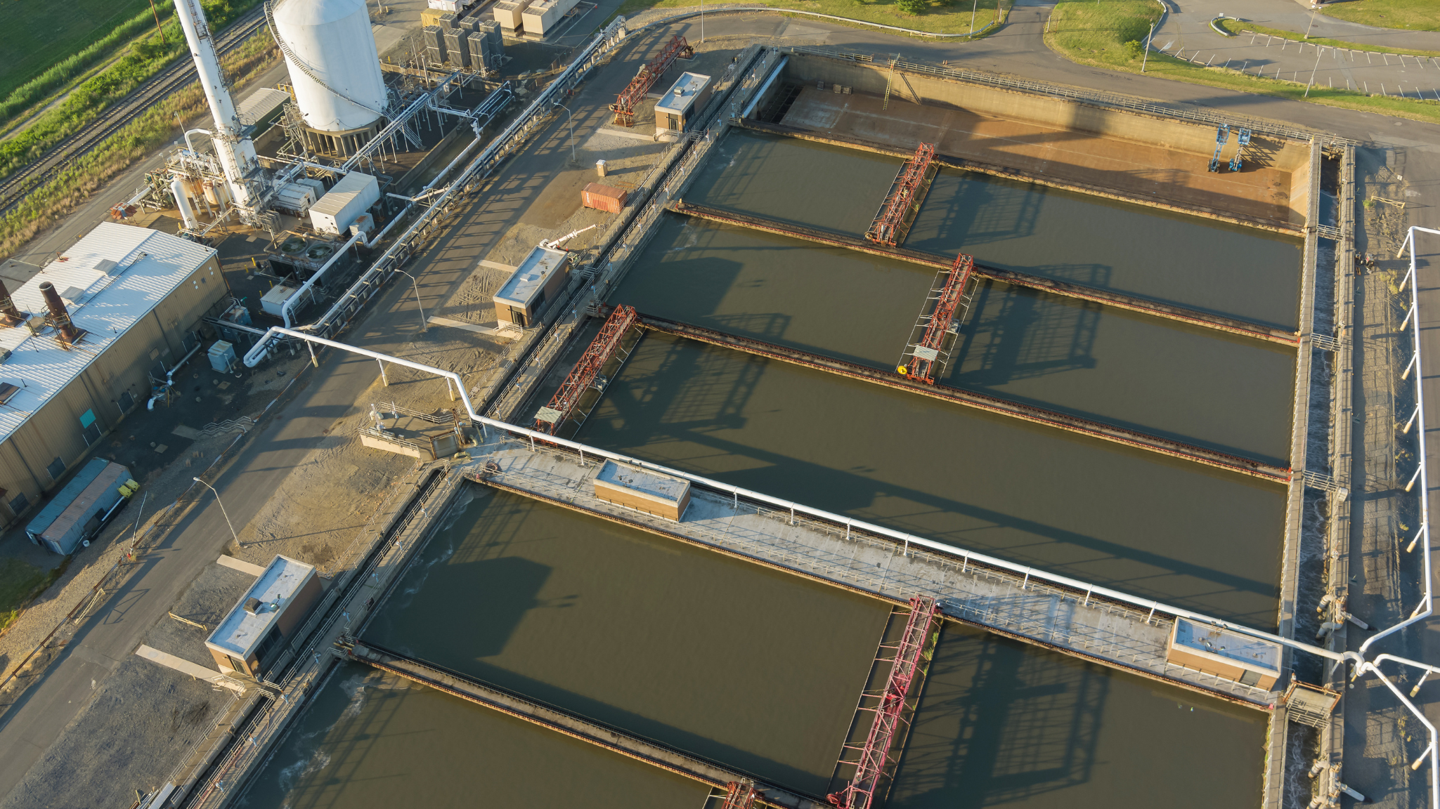 Industrial wastewater treatment basins used in managing alkalinity in water treatment systems