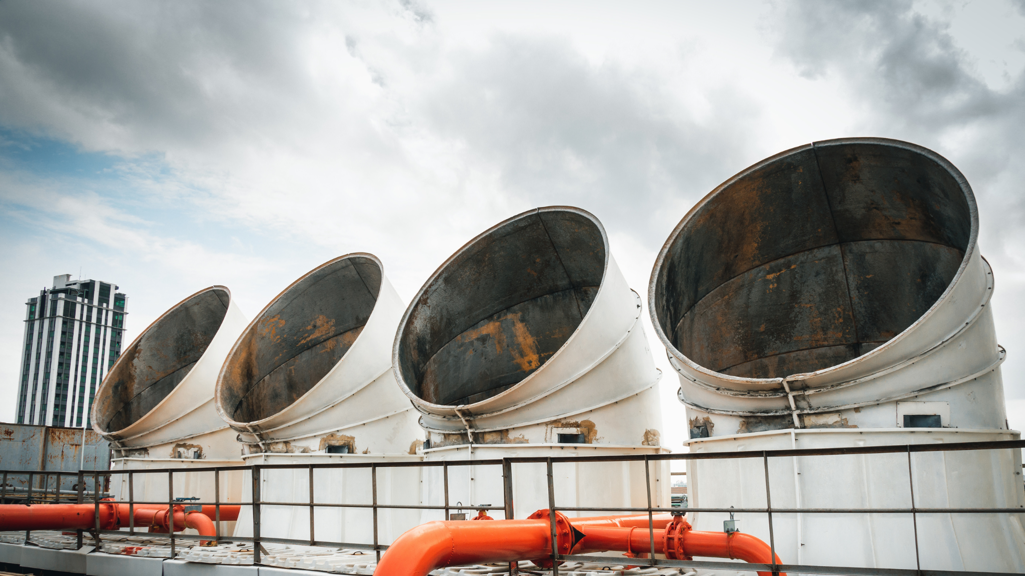 Industrial cooling tower fan stacks, commonly treated with bromine as a biocide for water treatment.