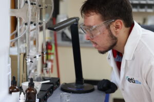 Laboratory technician analyzing industrial water samples using water treatment chemicals for system performance and safety