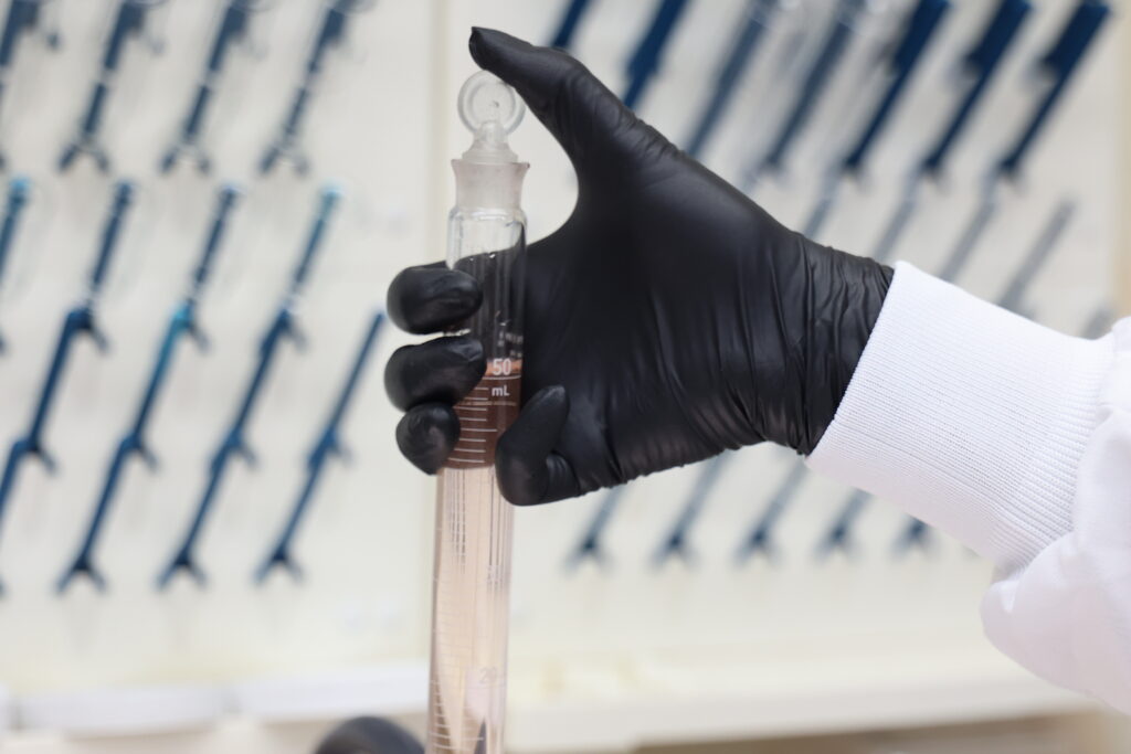 Water testing sample used to compare chlorine vs bromine in water treatment systems