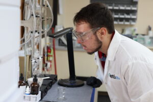 Technician performing water hardness testing using laboratory titration method