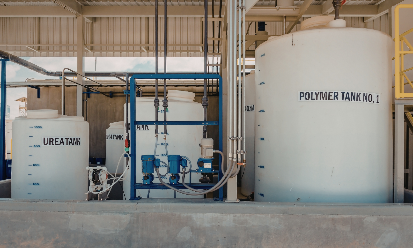 Industrial chemical blending system with storage tanks, pumps, and mixing equipment used in custom water treatment applications.