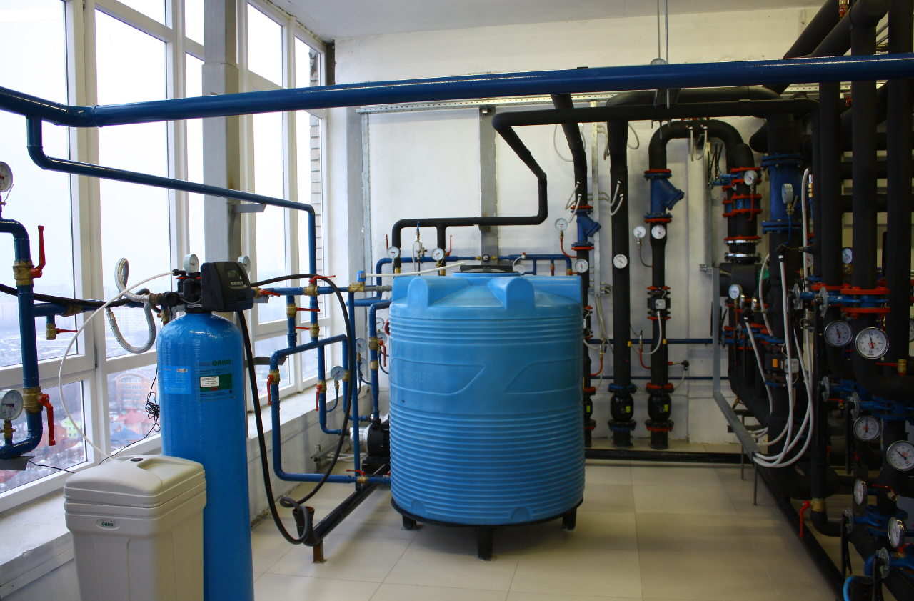 Industrial water treatment system with filtration equipment, chemical storage tank, and process piping supporting EPA water treatment compliance.