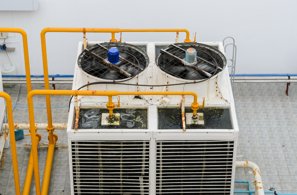 Open recirculating cooling towers require routine cleaning, microbial treatment, and monitoring to control biological accumulation on wetted surfaces.