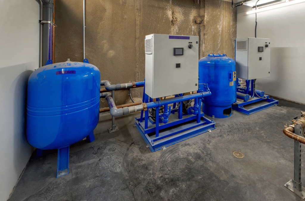 Industrial water treatment system with tanks, piping, pumps, and automated control panels