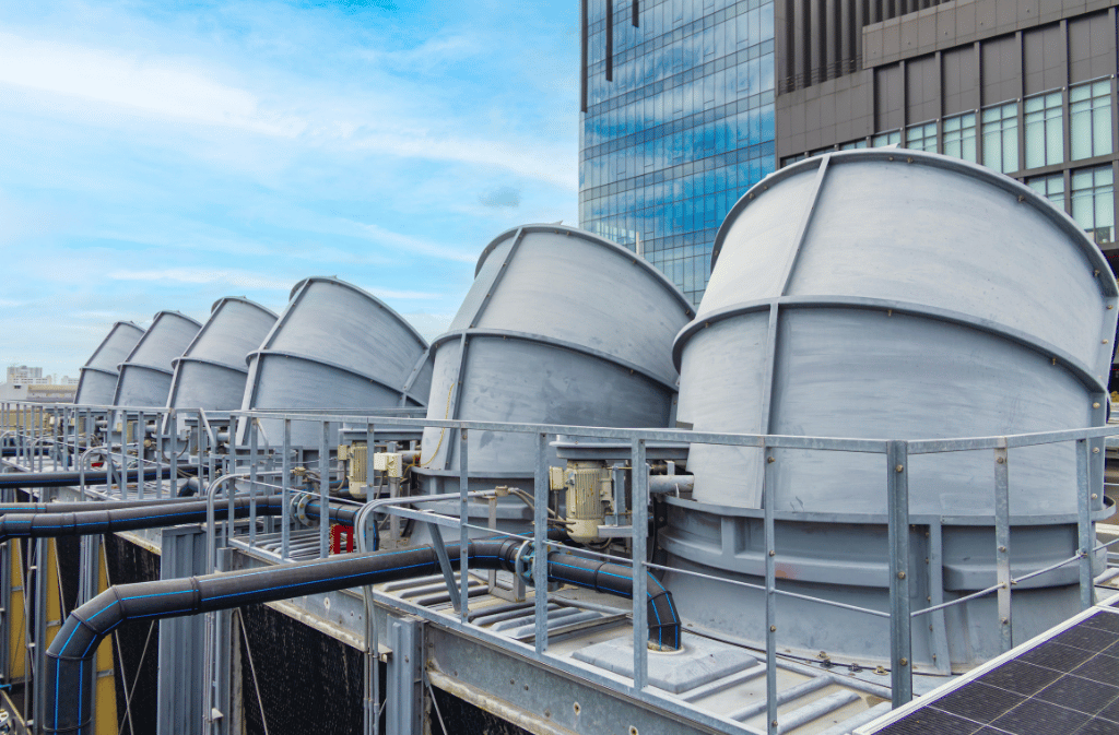 Rooftop cooling towers with associated piping and maintenance walkways.