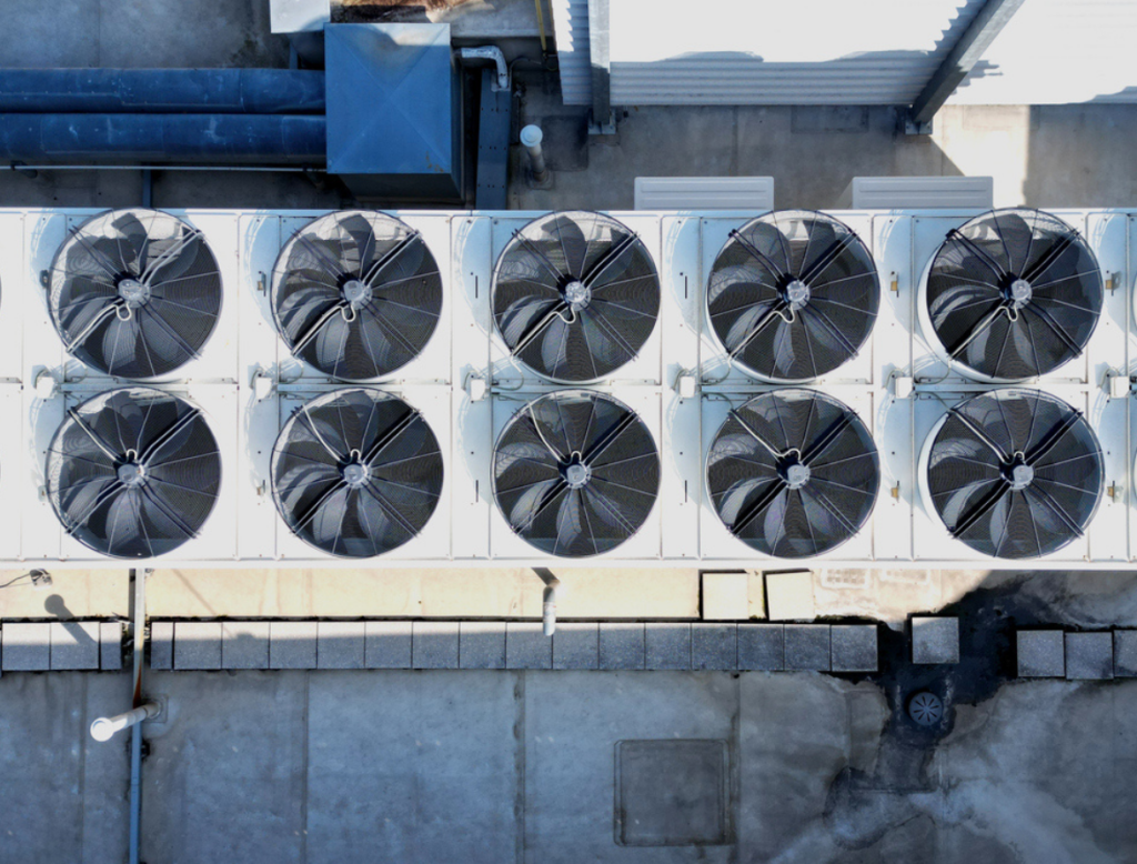 Overhead view of industrial cooling equipment with multiple fans.